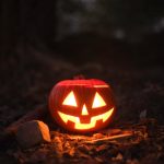 Glowing jack-o'-lantern in a spooky outdoor setting, perfect for Halloween themes.